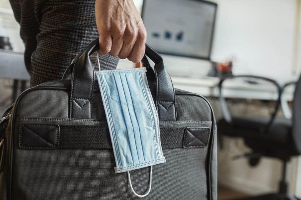 A businessperson walks to the computer to learn how to get your ppp loan forgiven